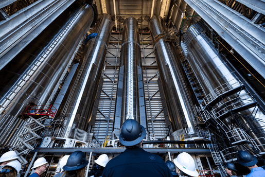 SpaceX workers with boosters in megabay